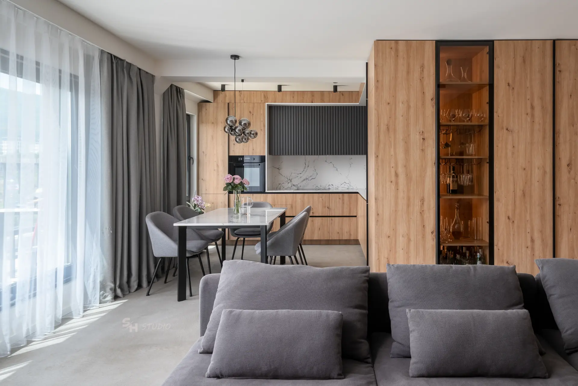 PHOBIA — living and dining area with full-height custom cabinetry