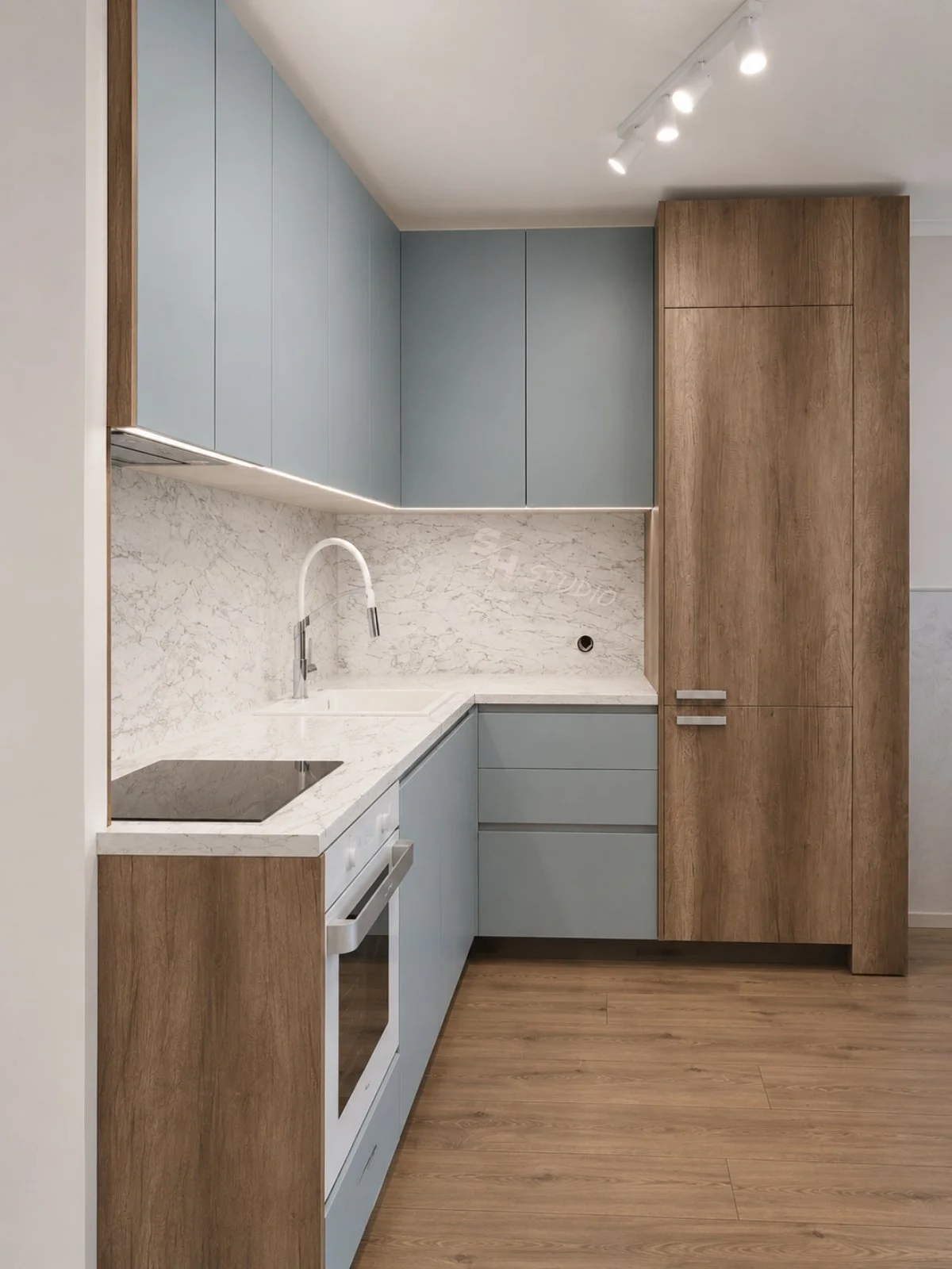 GB Residence — pale blue kitchen with marble-effect worktop and oak-effect tall unit