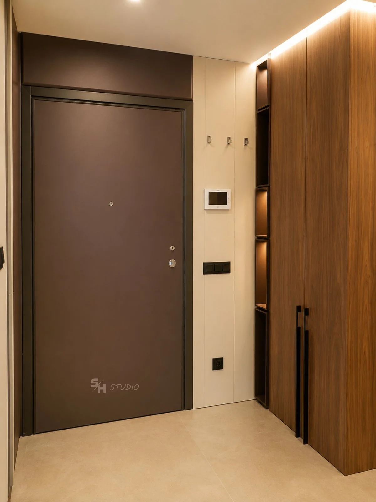 ADVH — entrance door with slim frame beside the walnut-veneered wardrobe with integrated shelving