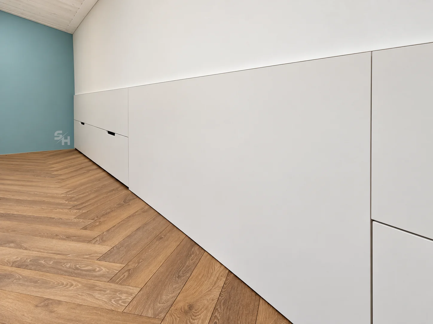 Attic Spaces — long low white cabinets under the attic slope