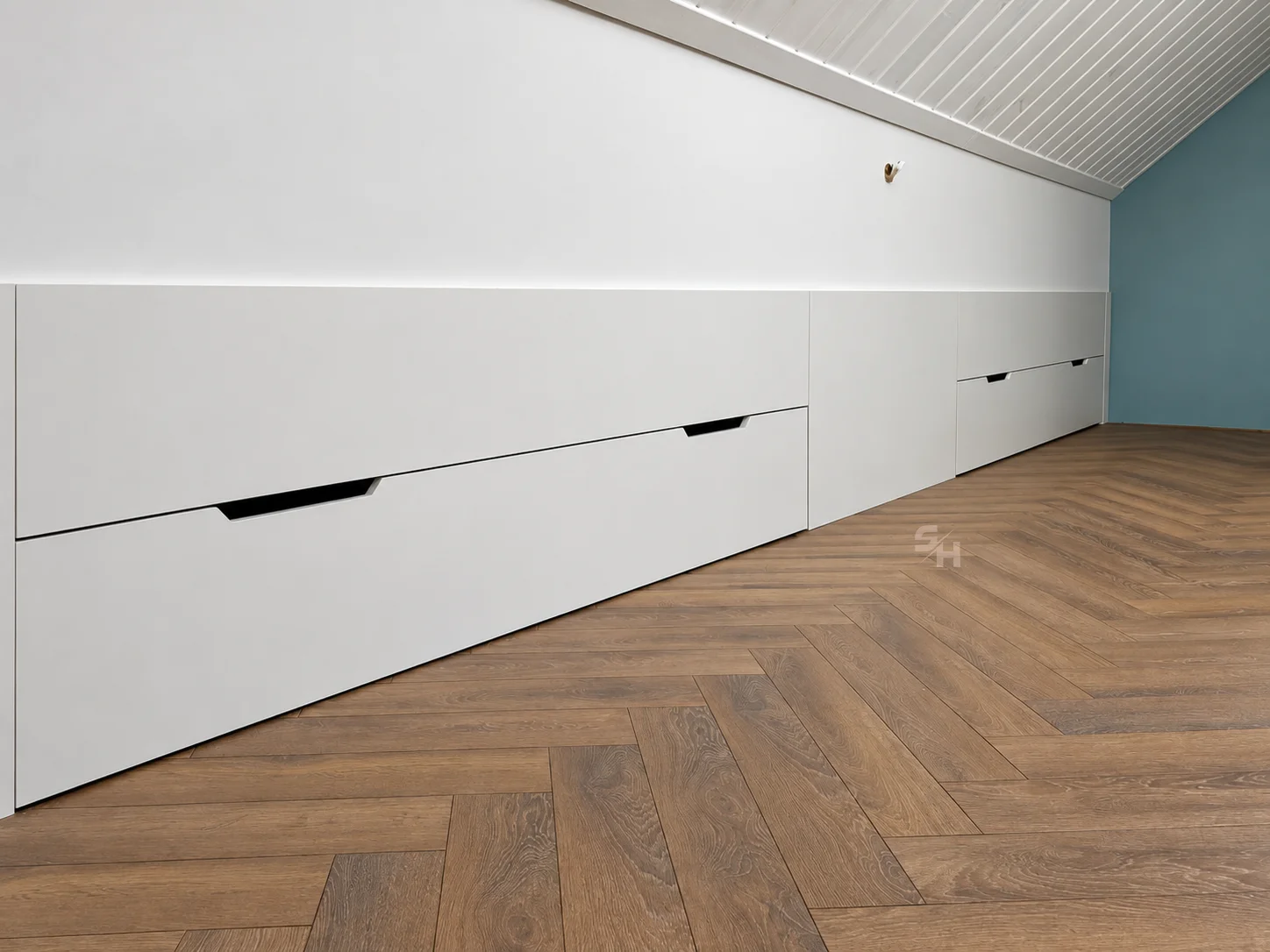 Attic Spaces — low white drawer run beneath the sloped ceiling