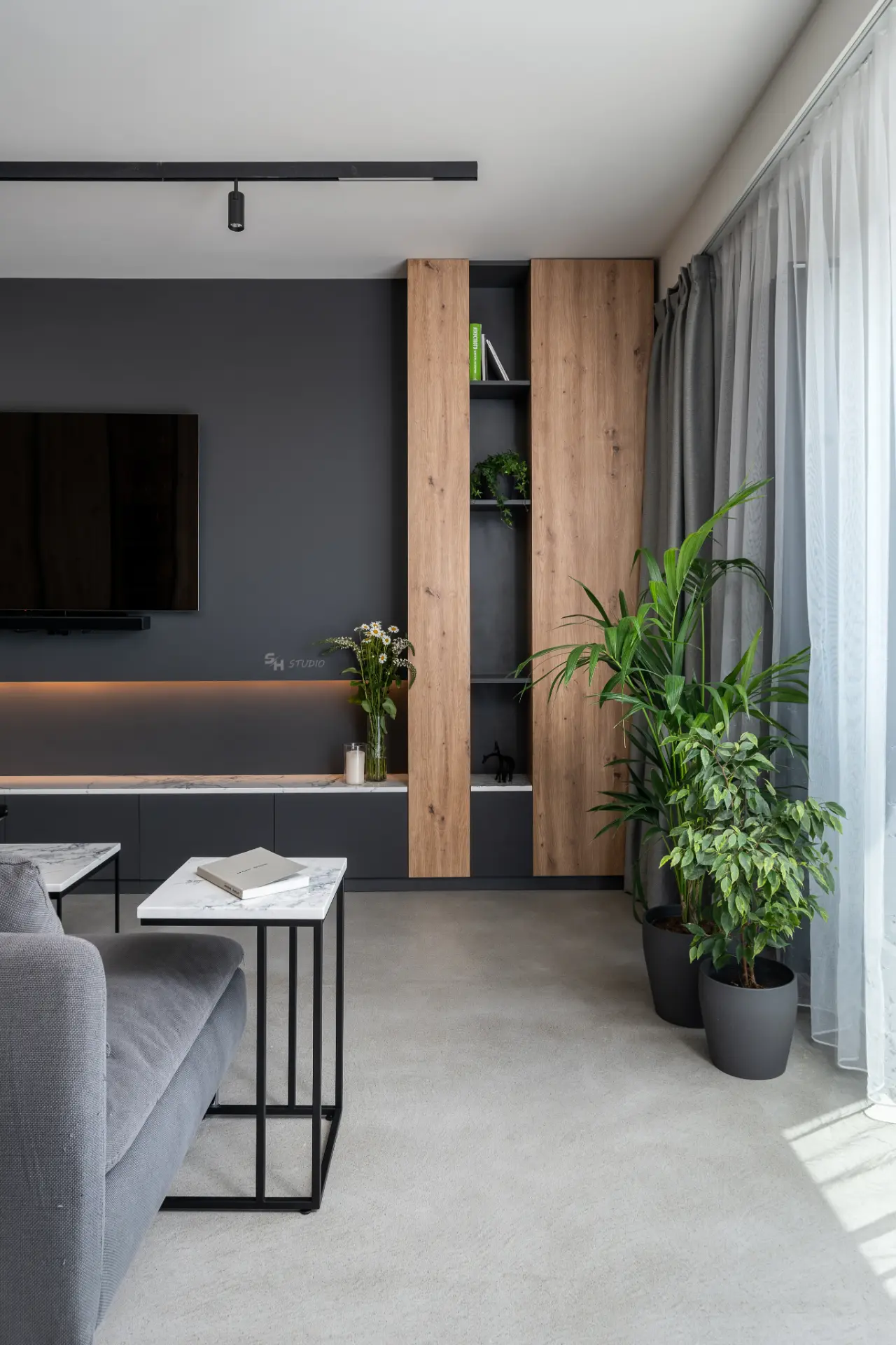 PHOBIA — living-room storage composition beside the full-height window