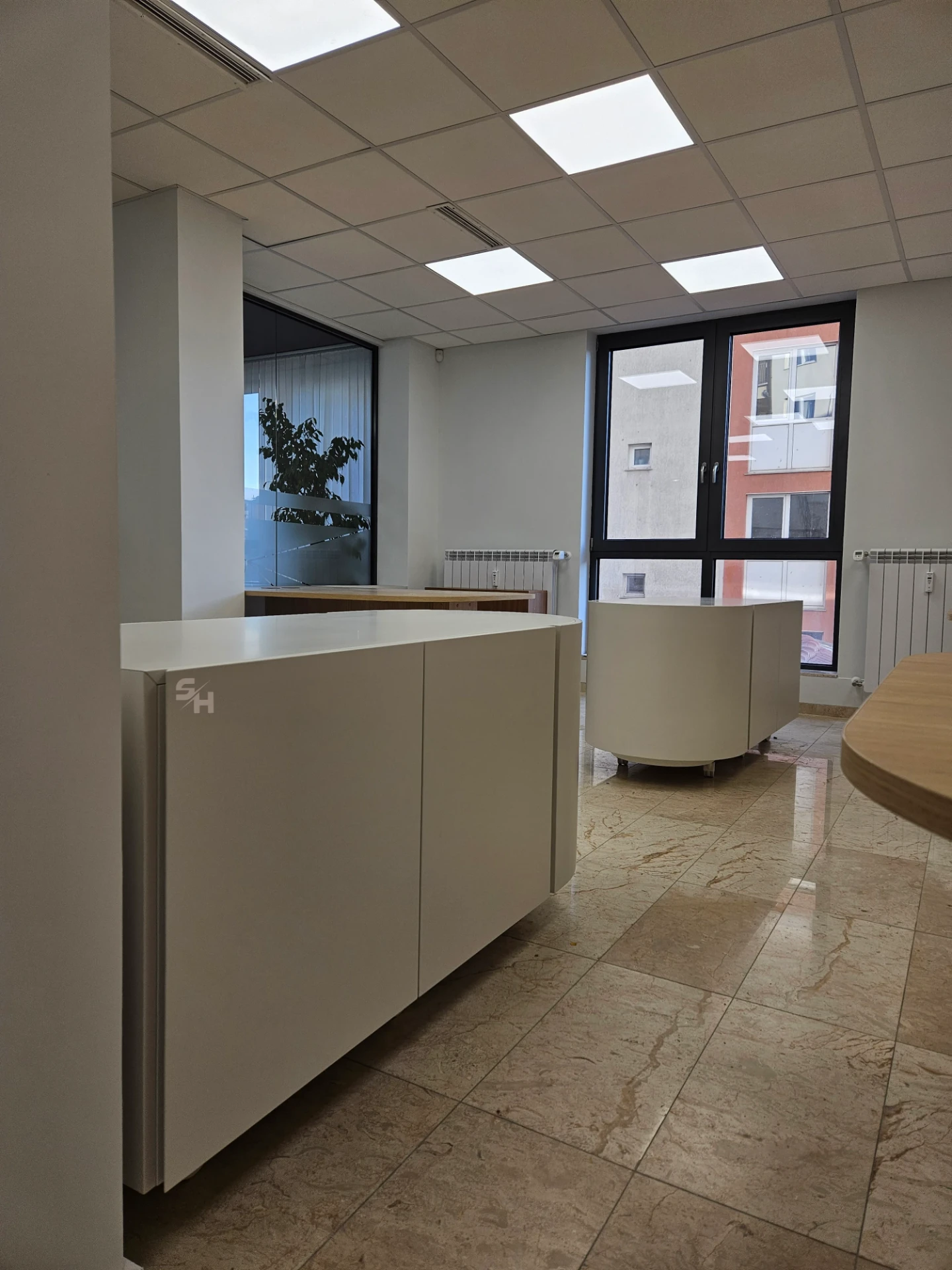 VDR Office — creative workspace with curved desks, filing wall and mobile curved cabinet