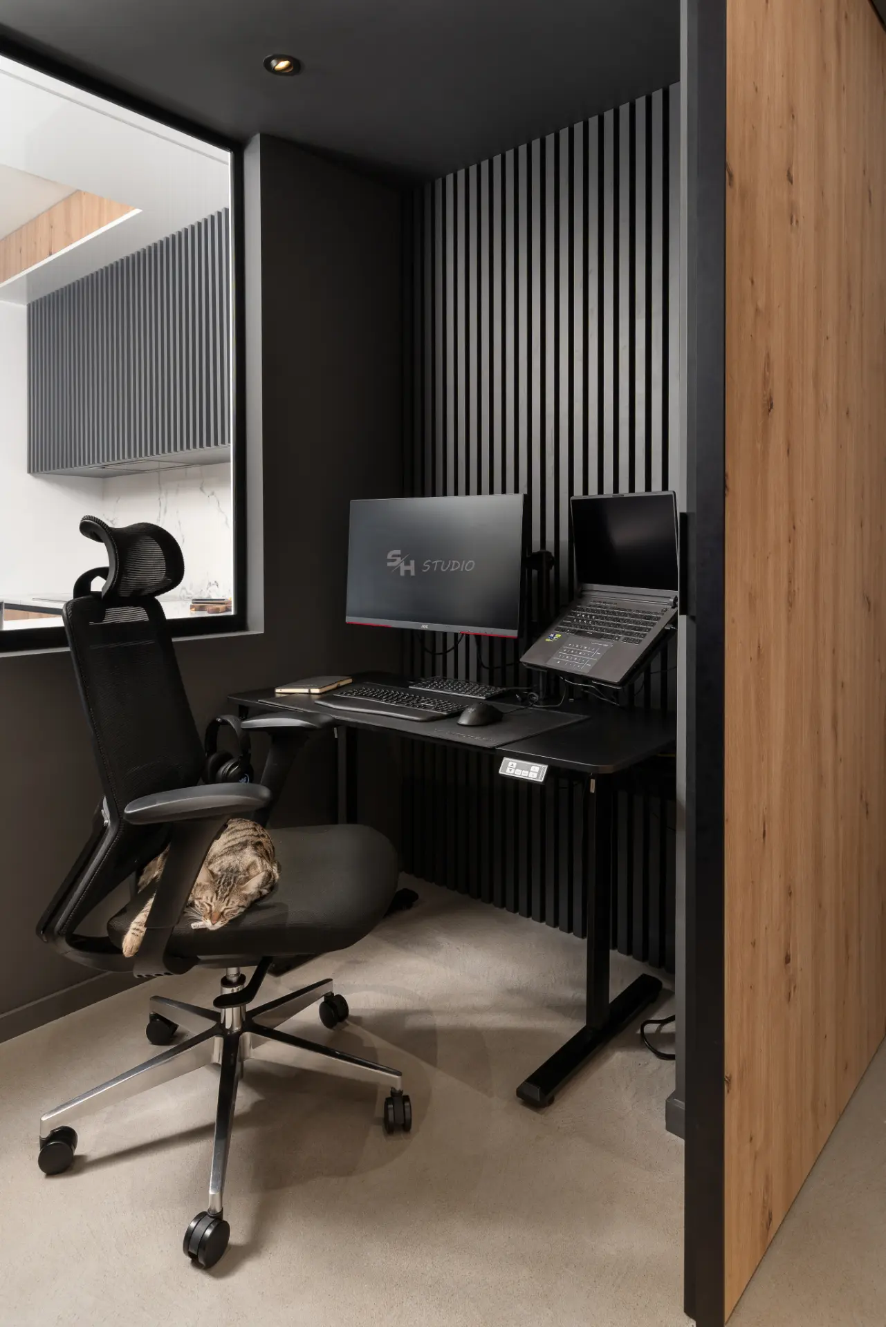 PHOBIA — compact home office with a dark slatted wall and timber cabinetry