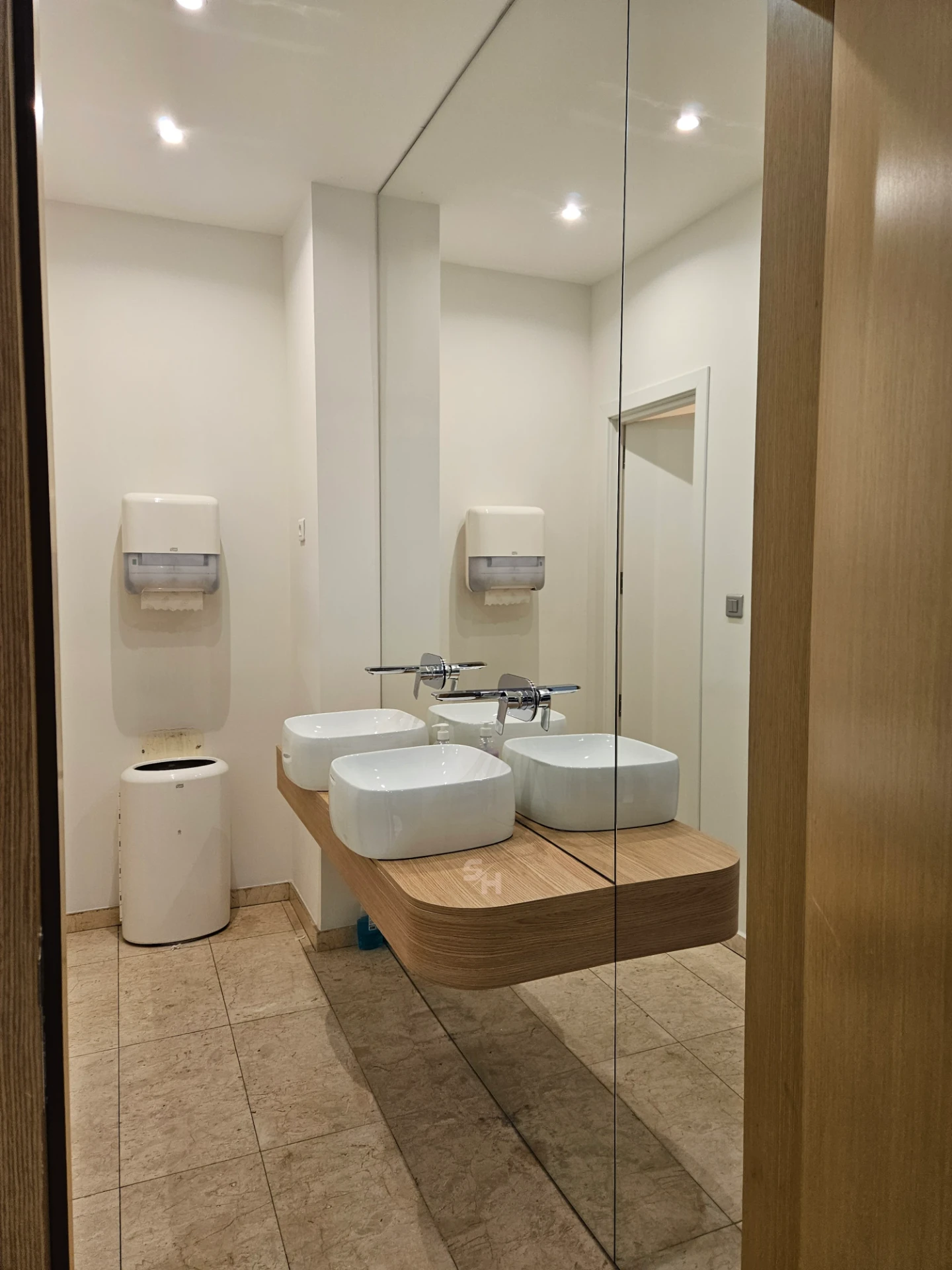VDR Office — WC lobby with cantilevered waterproof PVC sink counter and mirrored wall