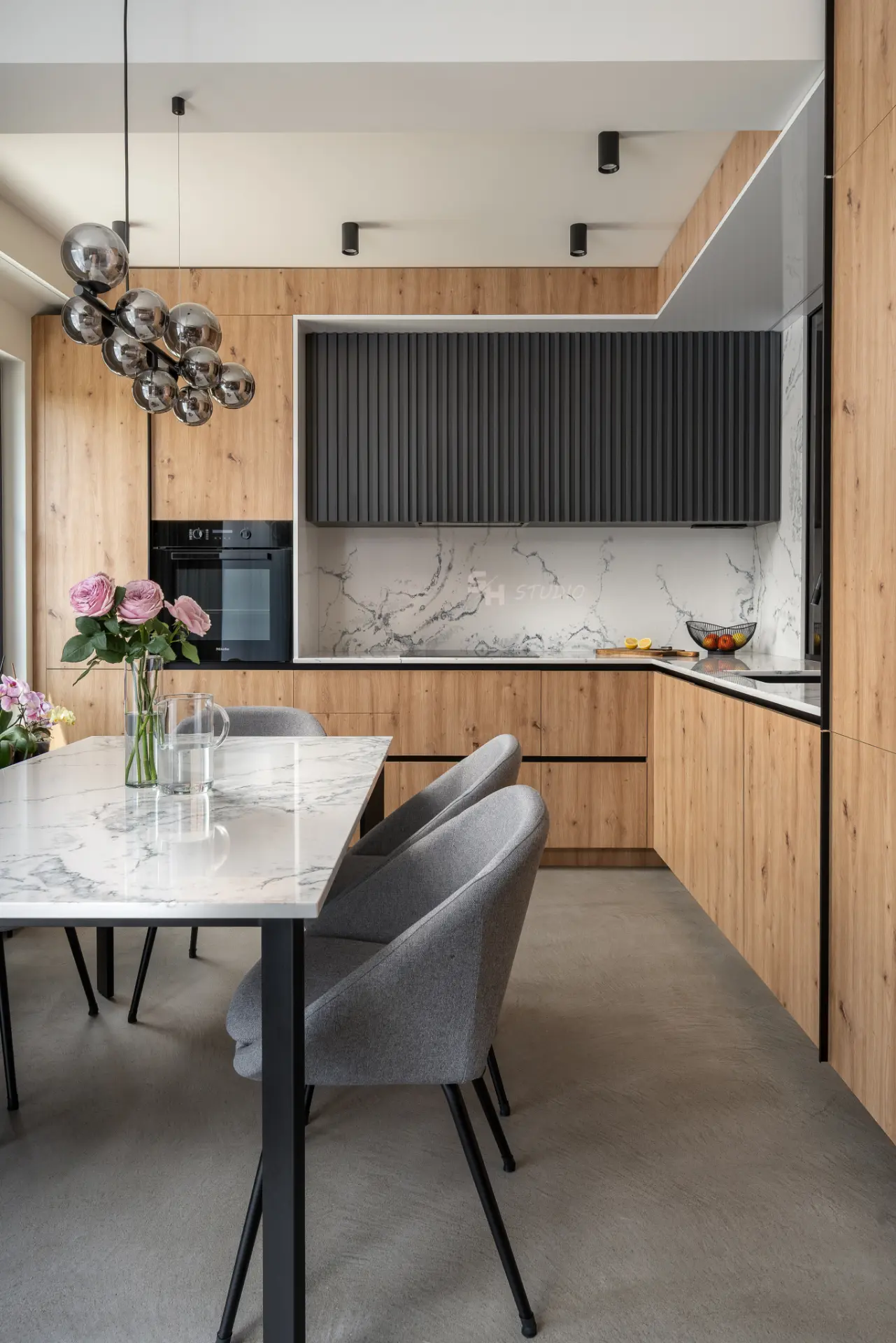 PHOBIA — kitchen and dining area with timber cabinetry and dark fluted fronts