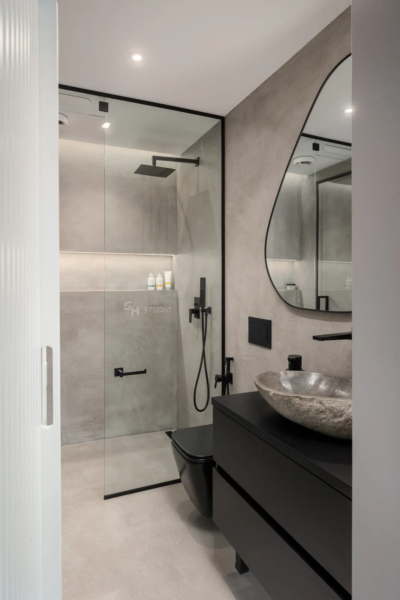 PHOBIA — bathroom with a dark wall-hung vanity and glazed shower enclosure