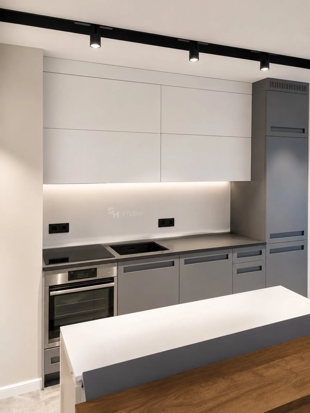 KDIA — compact two-colour kitchen with island and routed handles