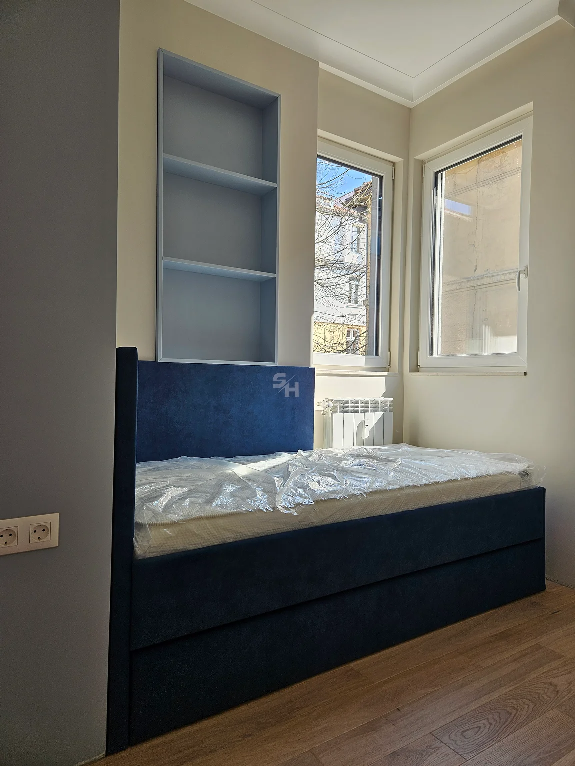 PSHM — children's room with upholstered bed and recessed shelves