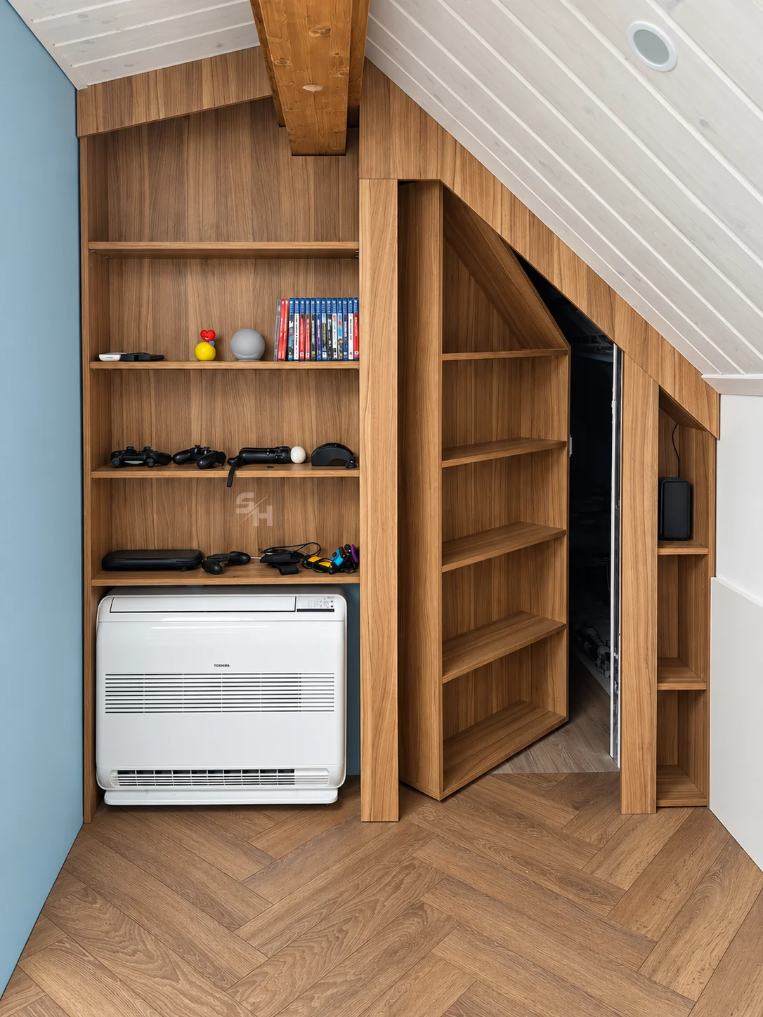 Attic Spaces — angled shelving with a concealed pivoting bookcase door