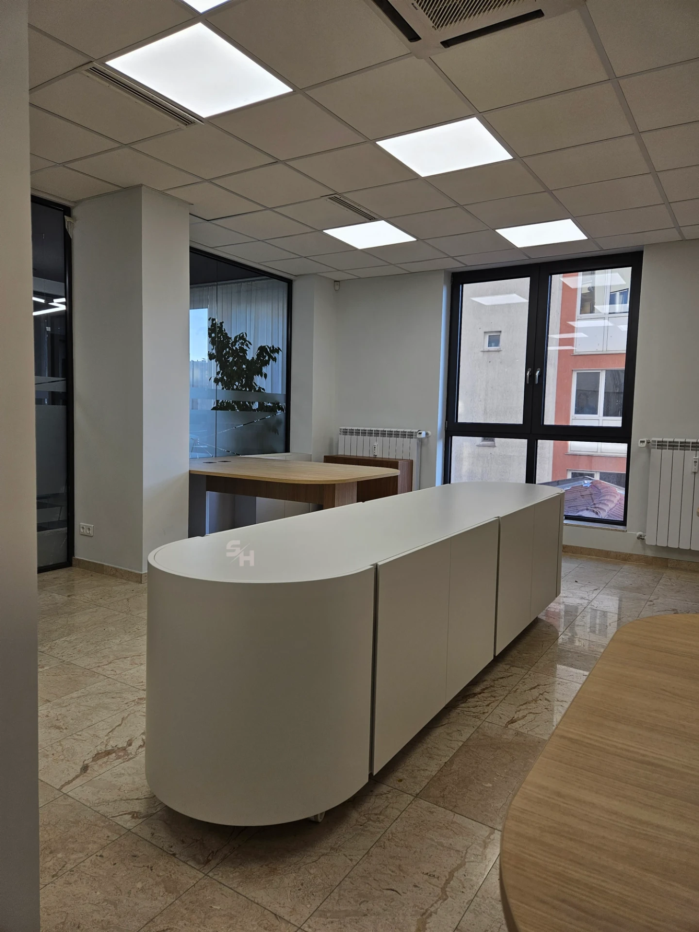 VDR Office — creative workspace with curved desks, filing wall and mobile curved cabinet