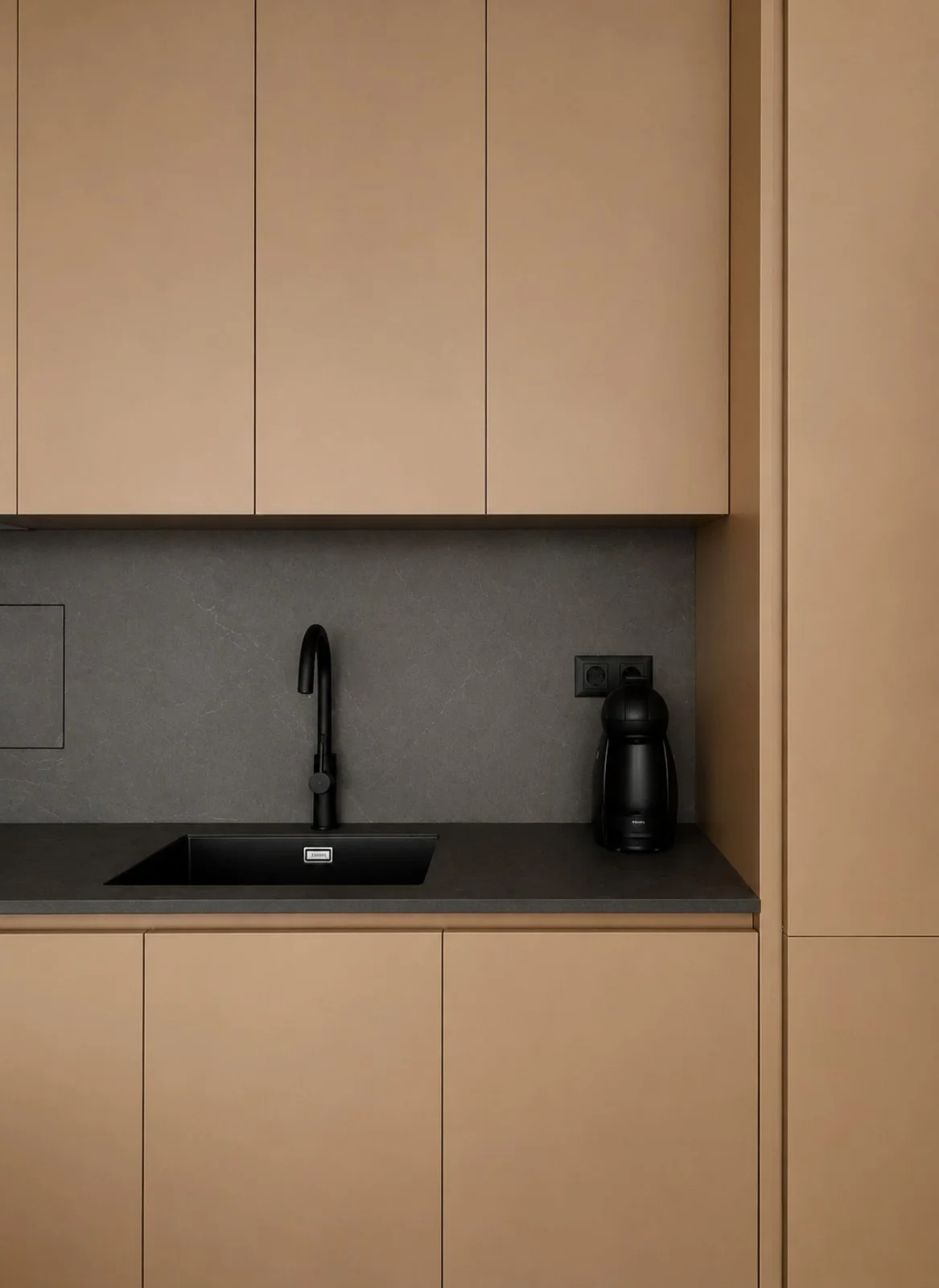 ETS1 — kitchen detail with black mixer tap and coffee machine on the dark worktop