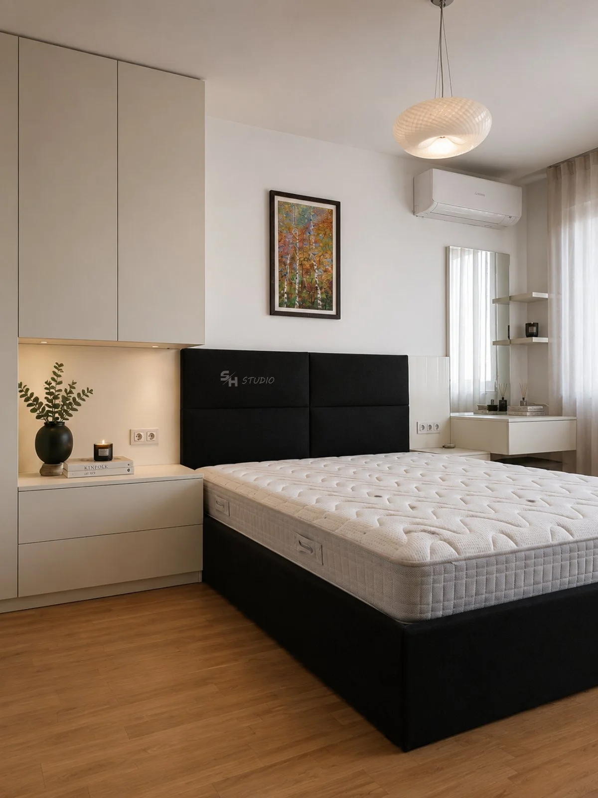 SHIR Residence — black upholstered bed with fitted white storage and dressing table