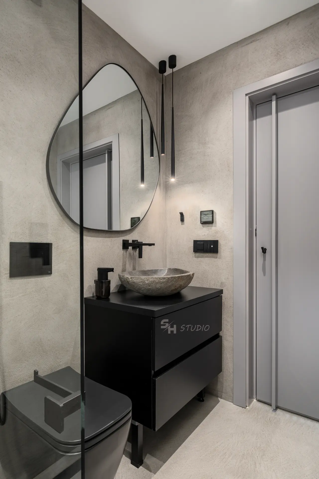 PHOBIA — bathroom vanity with dark drawers and an irregular mirror