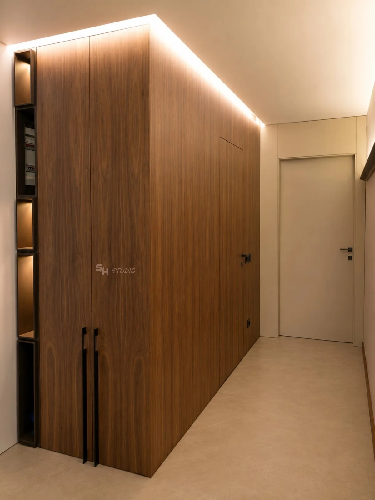ADVH — full-height walnut-veneered wardrobe with integrated shelving in the entrance hall
