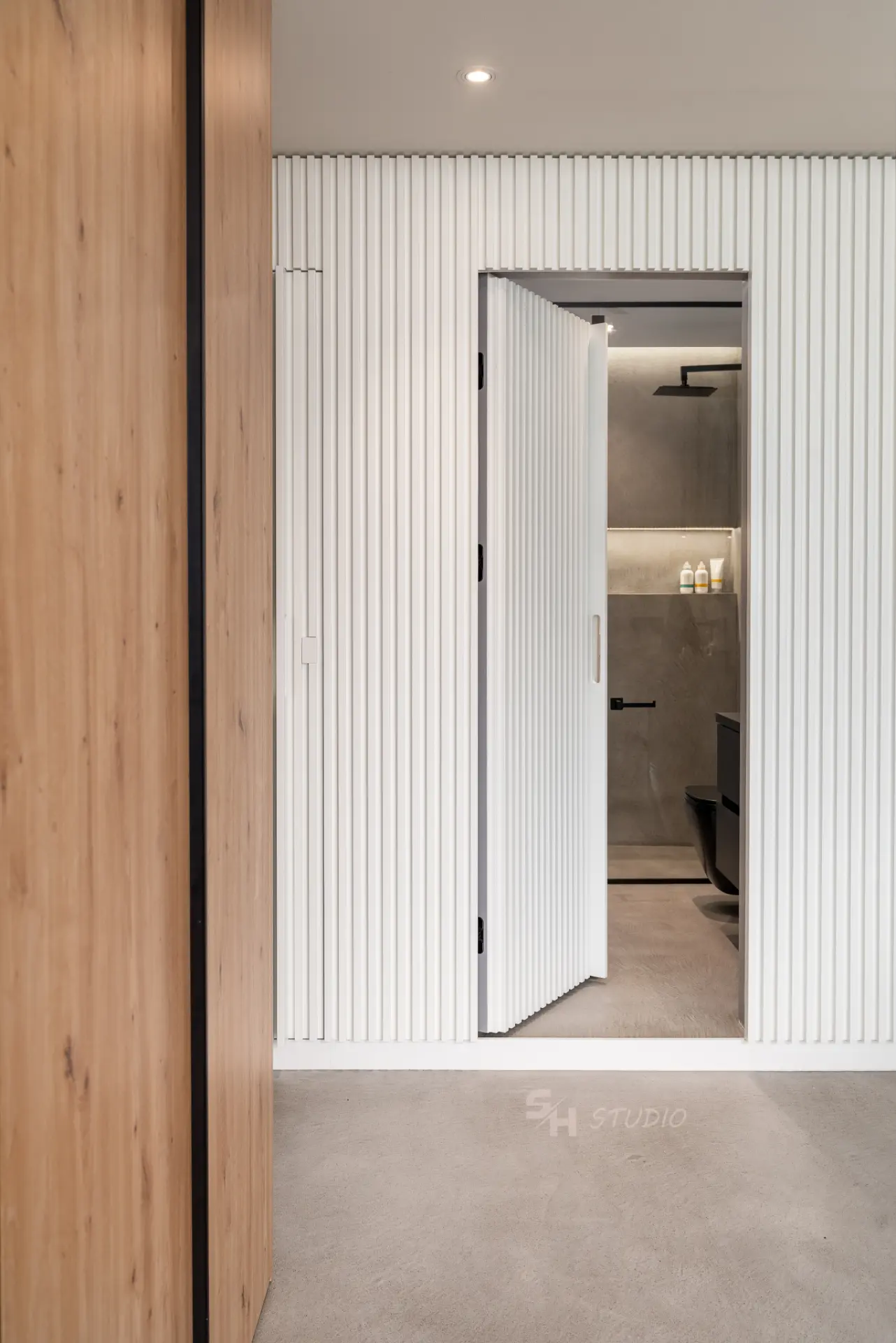 PHOBIA — concealed fluted door connecting the entrance hall and bathroom