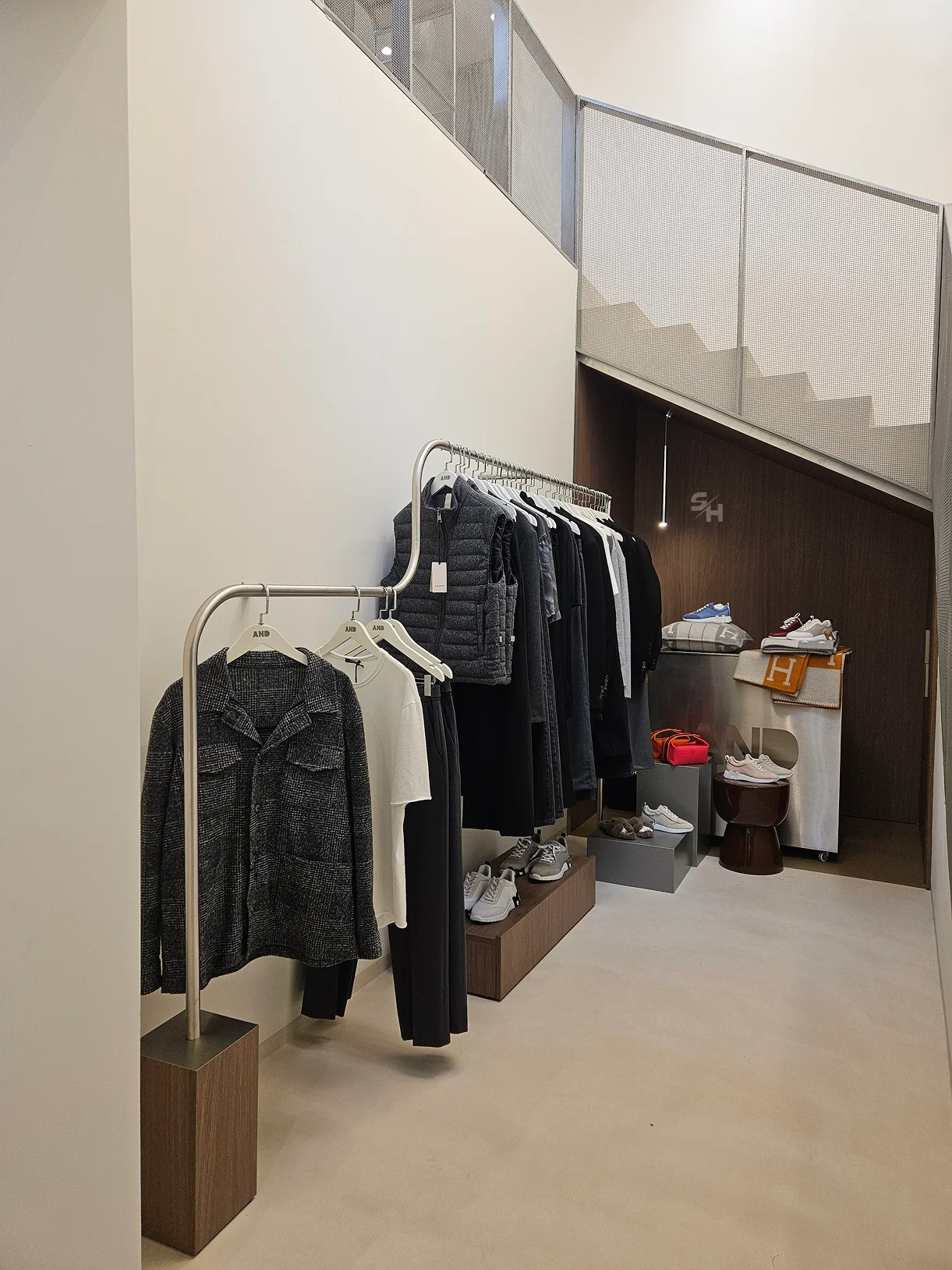 AND menswear store — counter, display alcoves and stair hall