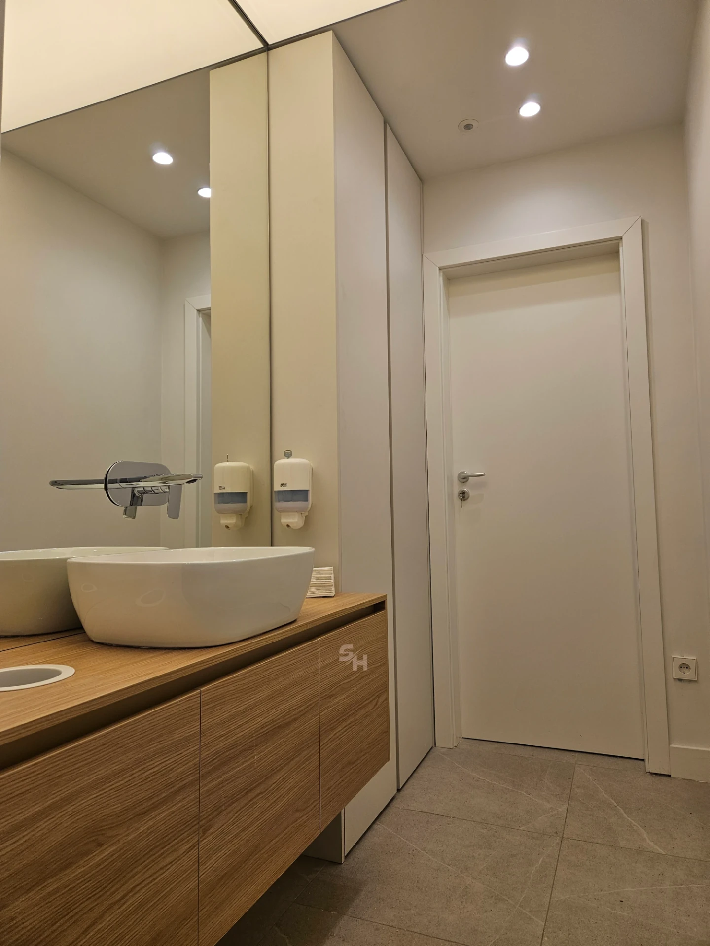 VDR Office — WC lobby with cantilevered waterproof PVC sink counter and mirrored wall