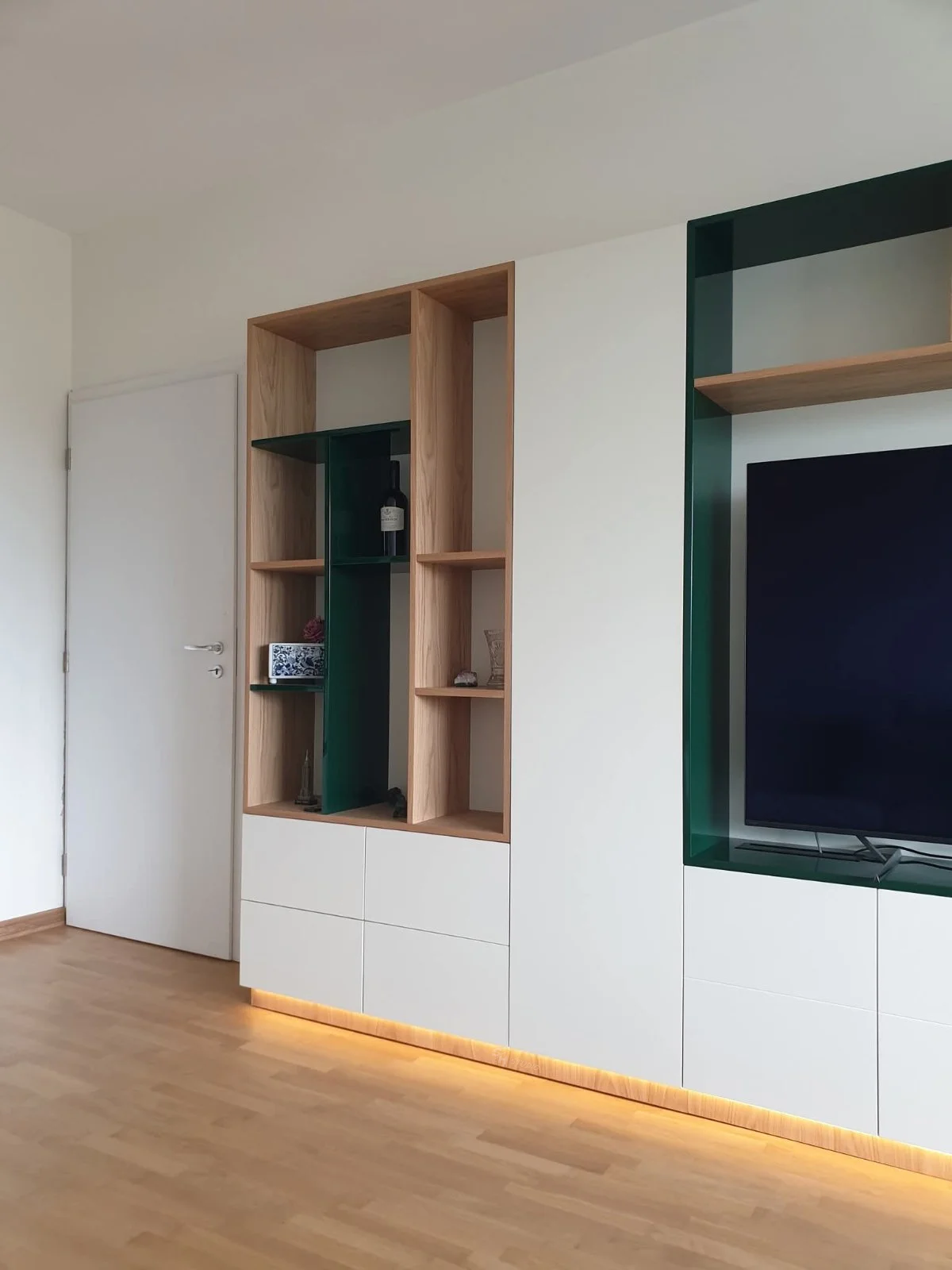 Living Room — open oak shelving with green display niches and white drawers
